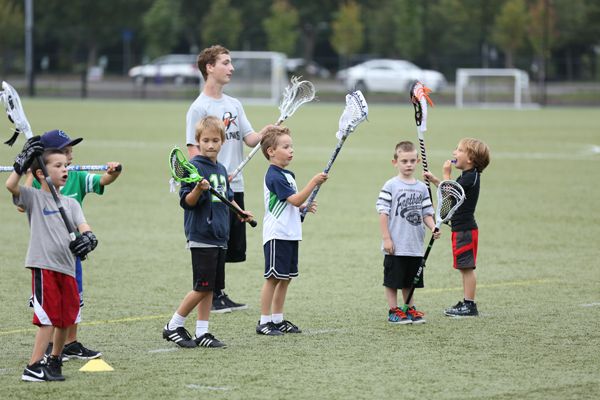 Young Fiddle Stix players practicing with small lacrosse sticks